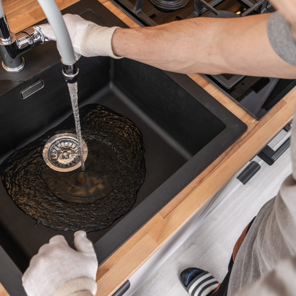 Plumbing Technician Installing Kitchen Sink and a Faucet. Water Supply Check.