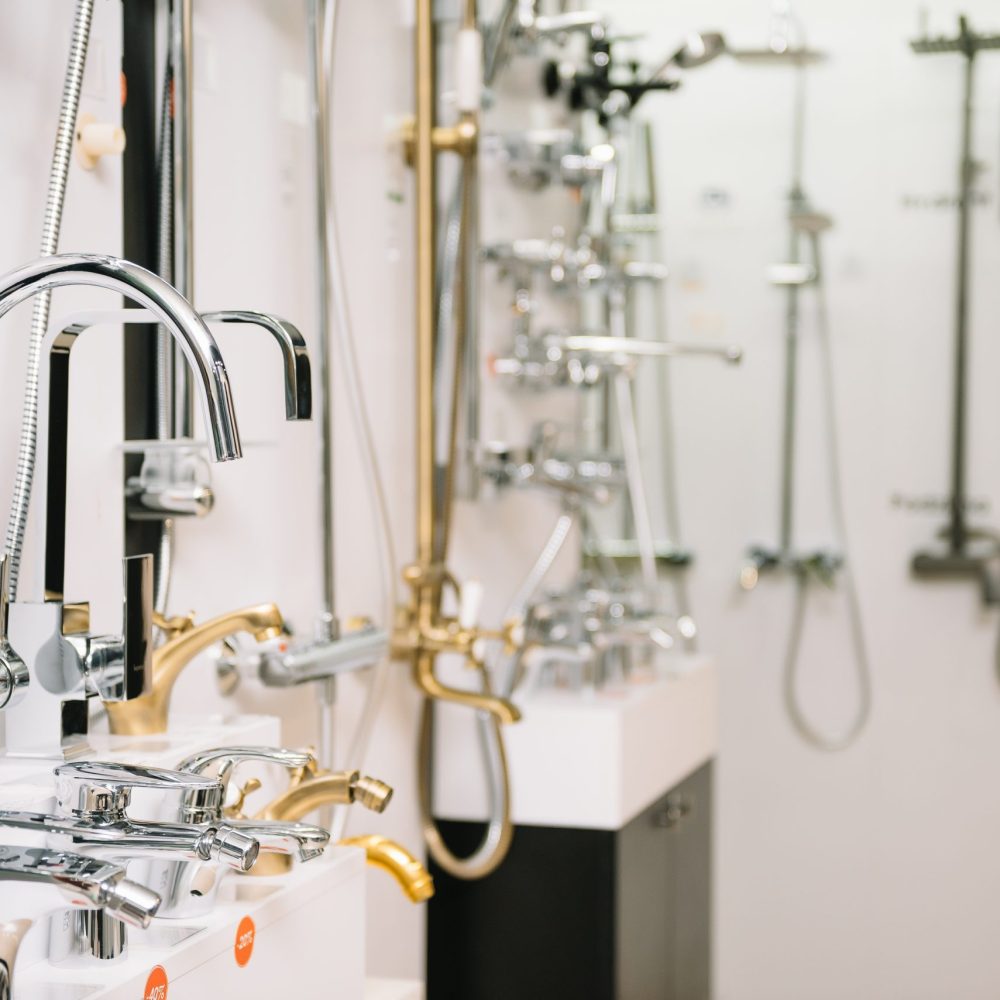 Rows of new faucets in plumbing shop, closeup