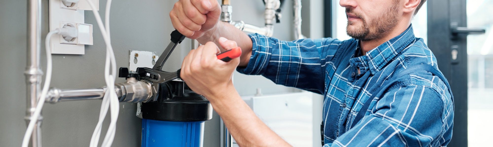 young-plumber-or-technician-installing-or-repairing-system-of-water-filtration.jpg